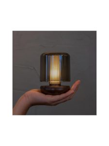 firefly table light humble bronze smoked lifestyle hand holding